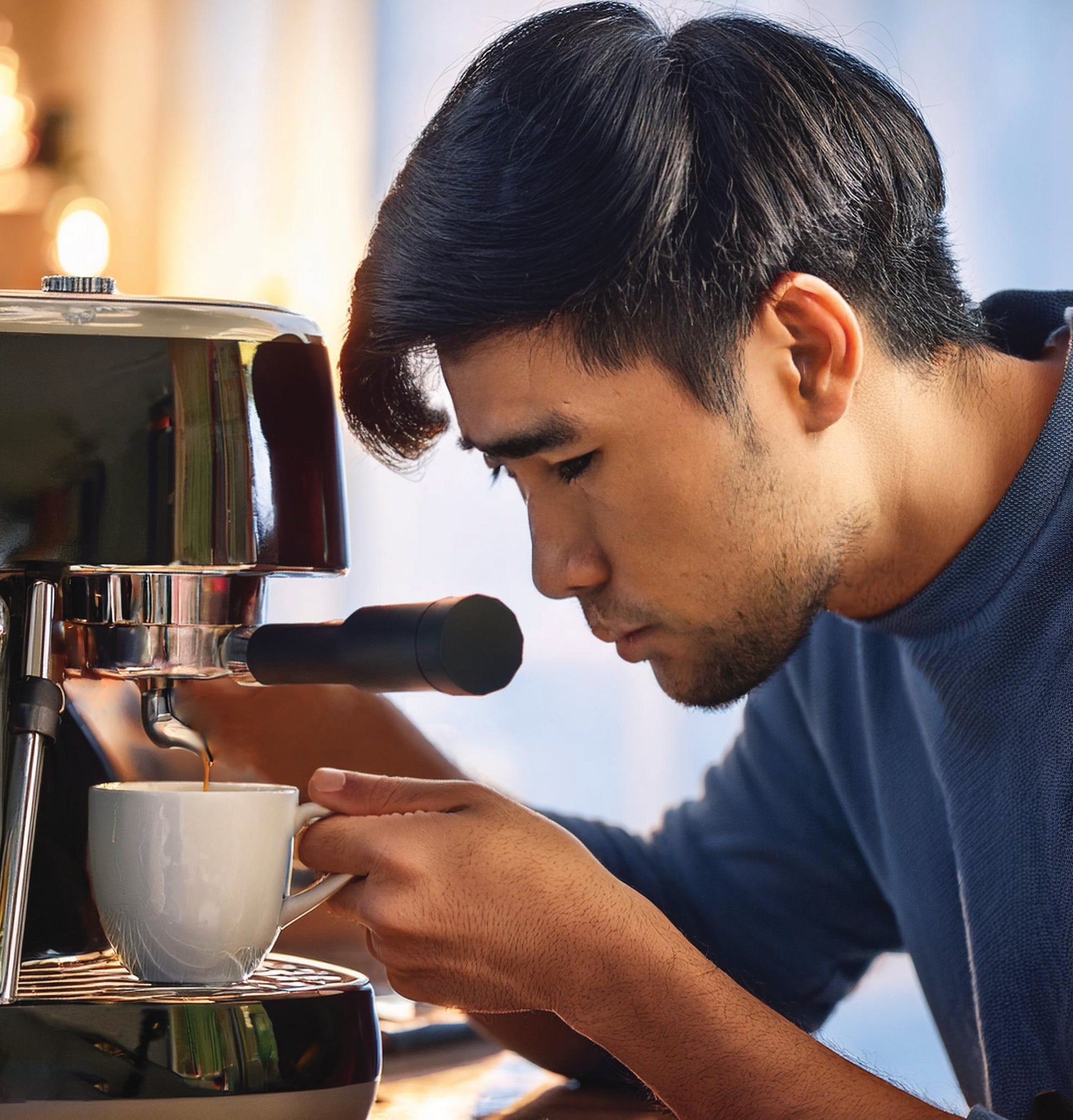 Man focussing on his espresso brewing.